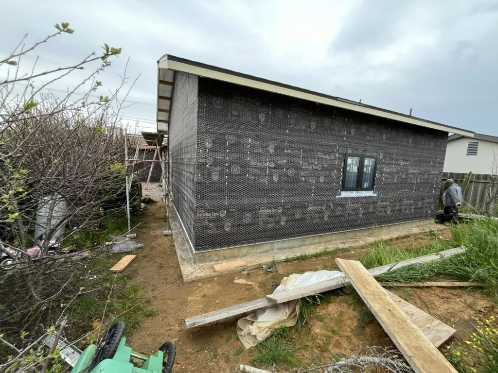 Detached ADU exterior during construction with sheathing and a sloped roof.