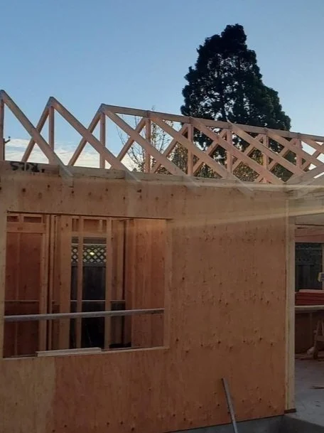 ADU timber wall framing and roof trusses before enclosure.
